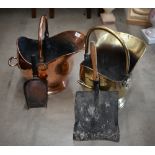 Two antique helmet scuttles (one copper, one brass) and two shovels (4)