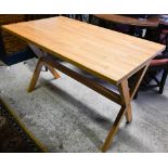 A modern beech table raised on cross ends, 113 cm x 66 cm x 73.5 cm h