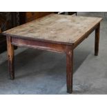 An antique rustic stripped pine kitchen dining table, on stained base with square supports, 165 cm