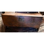 An antique elm six-plank coffer with carved front panel 102c m w x 35 cm d x 40 cm h
