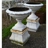 A large pair of old cast iron urn planters on shaped bases, 53 cm dia. x 74 cm h