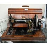 An antique Hengstenberg Justus sewing machine in marquetry inlaid carrying case (with key)