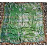 A machine-embroidered green silk table-cover with Japoniste design and tasselled fringe, 130 cm