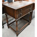An early 20th century oak two drawer canteen table on turned supports united by stretchers, 70 cm