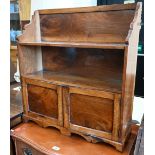 A small 19th century walnut cabinet with open shelves over a pair of panelled cupboards, 64 cm