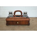 A Victorian walnut ink stand with two glass bottles, by Partridge & Cooper, London, 31 cm wide