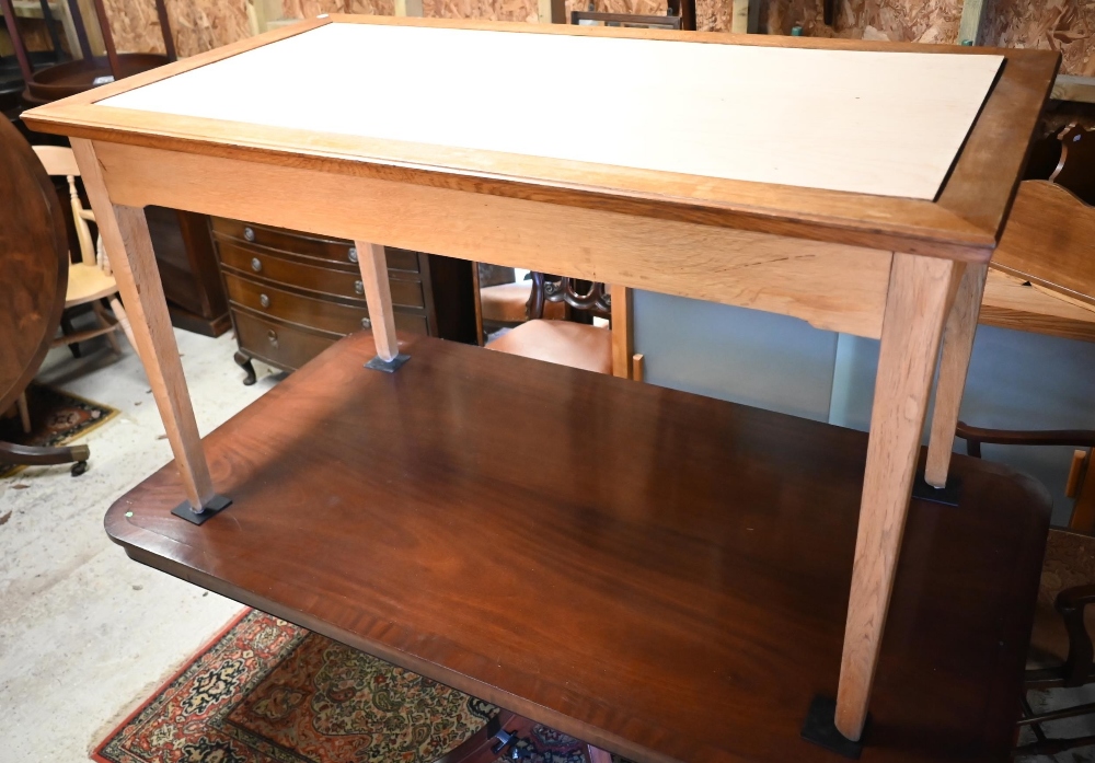 A modern oak  dining table with rectangular aperture to the top - previously fitted with a glass