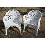 A pair of Victorian style cast metal garden chairs in the Coalbrookdale manner, with wood slat seats