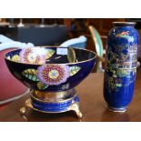 A Carlton Ware bowl on stand with floral and gilt decoration on a blue ground, 26 cm diam to/w a