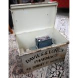 A vintage painted tin first-aid 'Dressings' box from Davies & Long's Pharmacy, Baker St (London),