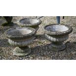 A trio of weathered cast stone Regency style urn planters (3)