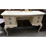 Willis & Gambier - A French style cream painted dressing table with four drawers on shell carved