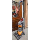 A Dyson model DC24 compact upright vacuum cleaner hoover