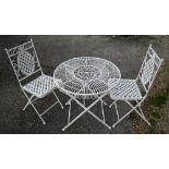 An old wrought circular garden table to/w a pair of matching chairs (3)