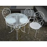 A circular glass top wrought steel terrace table to/w three chairs