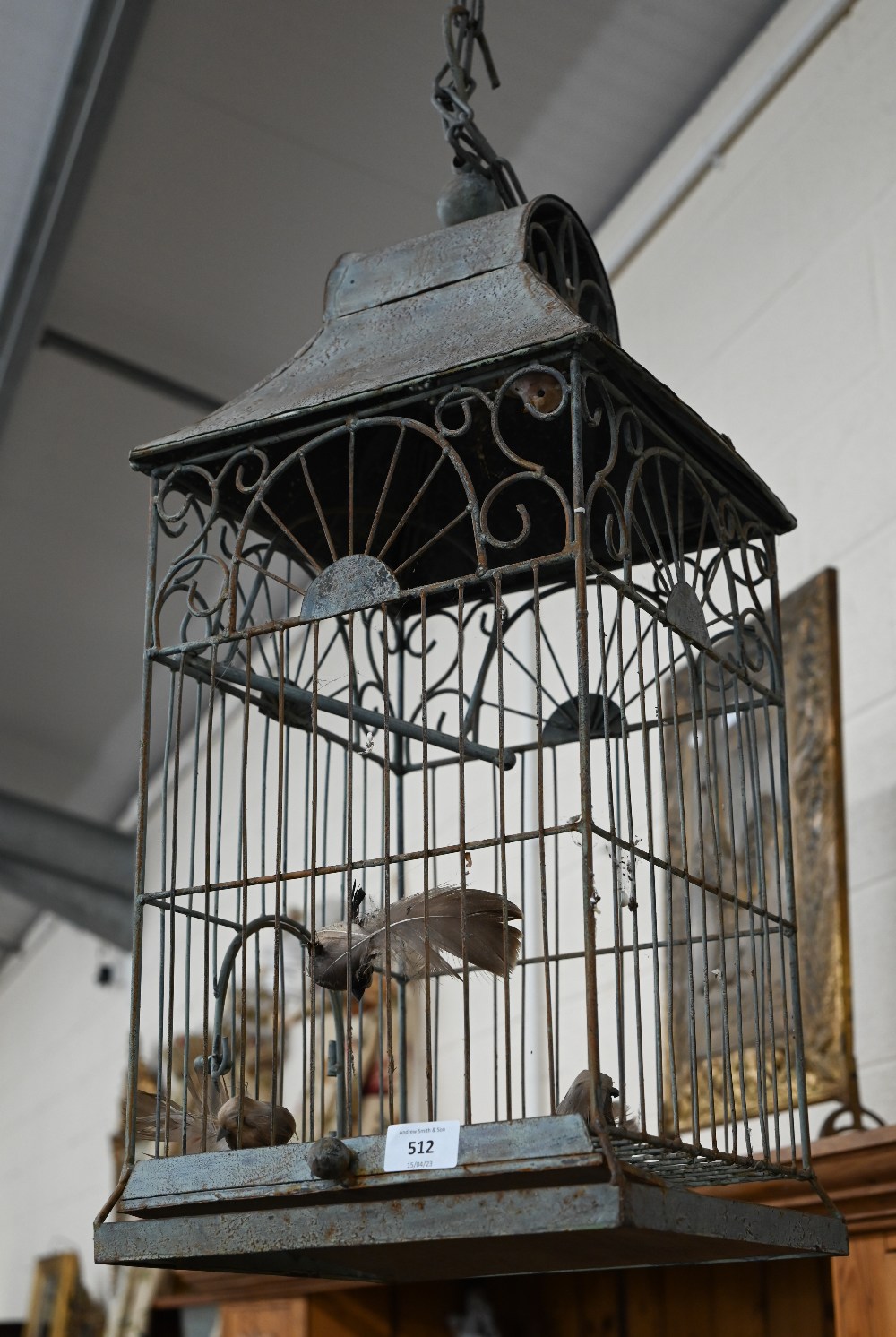 A wire and tin bird cage, 64 cm high