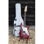 A James Tyler Variax red electric guitar c/w 'Line 6' soft gig bag, 'pilots Handbook', charger and