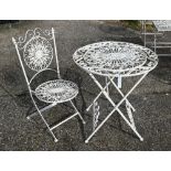 An old wrought circular garden table and matching chair (2)