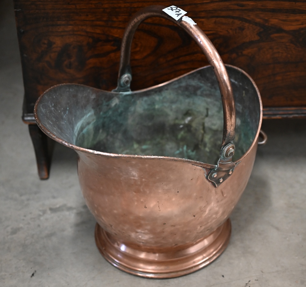 A Victorian copper coal helmet with swing handle