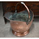 A Victorian copper coal helmet with swing handle