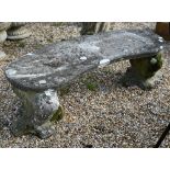 A weathered cast stone three piece garden bench