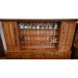 A substantial waxed pine dresser in two sections, the top with slatted back and three open shelves