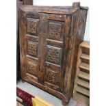 An Indonesian hardwood rustic pantry cupboard with carved panelled doors, a/f, 108 cm wide x 42 cm