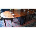 A 19th century mahogany extending dining table, the pair of demi lune ends united by drop leaf