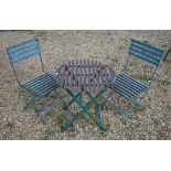 A contemporary distress painted circular garden table and pair of chairs (3)