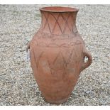 A large terracotta two handled classical urn, 72 cm high