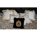 Four silk embroidered scatter cushions to/w a black velvet cushion with braided crown decoration and