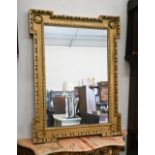 A Georgian style mirror in gilt egg and dart moulded frame with shell corner decorations, 96 cm high