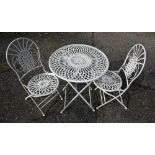 An old wrought circular garden table to/w a pair of matching chairs (3)