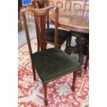 A set of six Edwardian walnut marquetry inlaid dining chairs with overstuffed green upholstery (6)