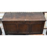 A large antique oak coffer/blanket chest with hinged top and carved panelled front adapted into