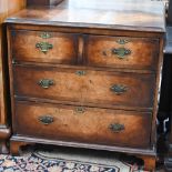 A small antique walnut chest of two short over two long drawers raised on shaped bracket feet, 82 cm