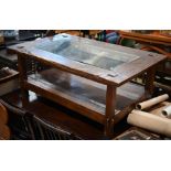 Rustic stained hardwood coffee table with inset glass top and open undertier, 126 cm wide x 74 cm