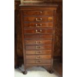 Edwardian walnut ten drawer music cabinet, the top with inset silver presentation plaque, 54 cm w