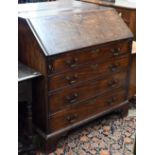 A George III mahogany fall front bureau with fitted interior and four long graduating drawers on