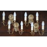 Four brass twin-branch wall sconces with beaded wall plates