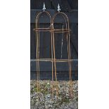 A pair of weathered steel arrowhead obelisks (2)