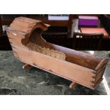 An old pine miniature/doll's cradle, 52 cm wide