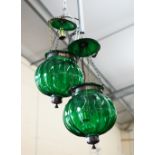 A pair of Hindi style brass mantle green glass pendant lamps of lobed gobular form (2)