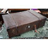A 1920s wax-canvas and bentwood bound suitcase with leather corners, stencilled ownership and