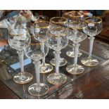 A set of eight gilt-rimmed wine glasses with airtwist stems, 19.5cm high