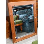 A rectangular leaded and stained glass wall mirror in moulded pine frame, 96 cm wide x 76 cm high