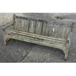A weathered slatted teak three-seater garden bench, 184 cm wide