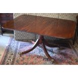 A Victorian mahogany tilt top dining table, raised on a gun barrel support to four swept legs, on