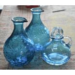 A Nina Campbell blue glass jug to/w two moulded blue glass carafes (3)