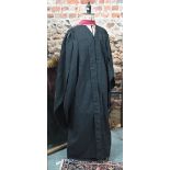 An academic gown with crimson stole